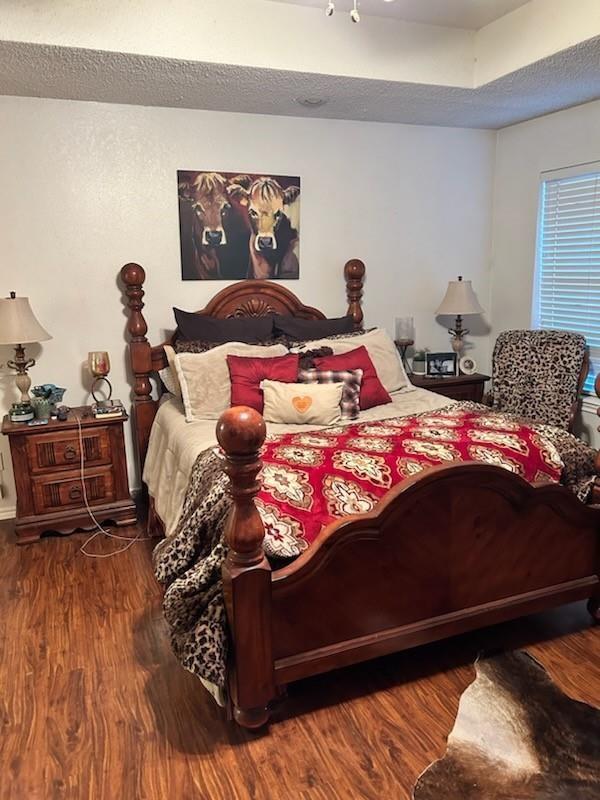 bedroom featuring dark hardwood / wood-style flooring