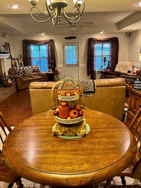 dining area featuring hardwood / wood-style floors, a tray ceiling, and an inviting chandelier