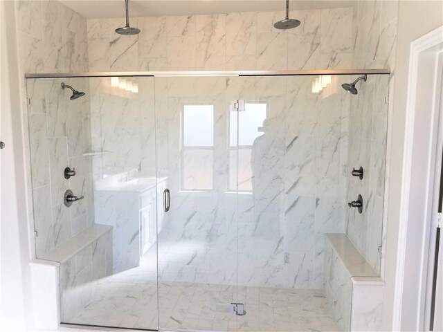 bathroom featuring a shower with shower door