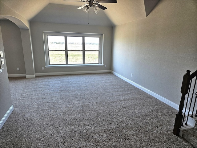 spare room with carpet floors, vaulted ceiling, and ceiling fan