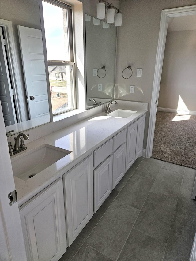 bathroom featuring tile patterned floors, vanity, and a healthy amount of sunlight