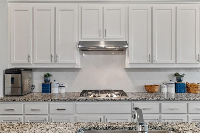 kitchen featuring white cabinetry, backsplash, and stainless steel gas cooktop