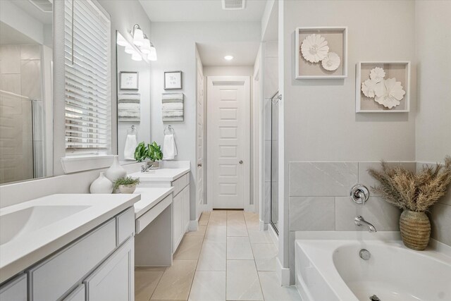 bathroom featuring tile patterned flooring, vanity, and independent shower and bath