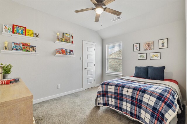 carpeted bedroom with ceiling fan and vaulted ceiling