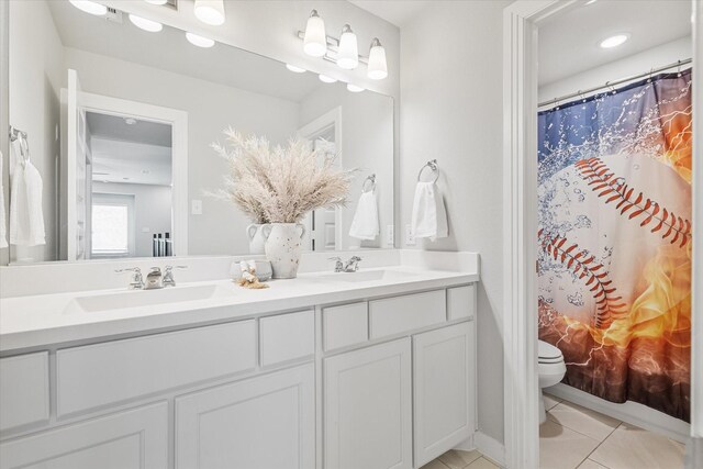 bathroom with tile patterned floors, toilet, a shower with shower curtain, and vanity