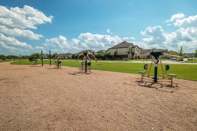 view of community featuring a residential view, a lawn, and playground community