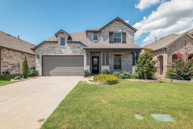 view of front of home featuring a front yard, a shingled roof, concrete driveway, a garage, and brick siding