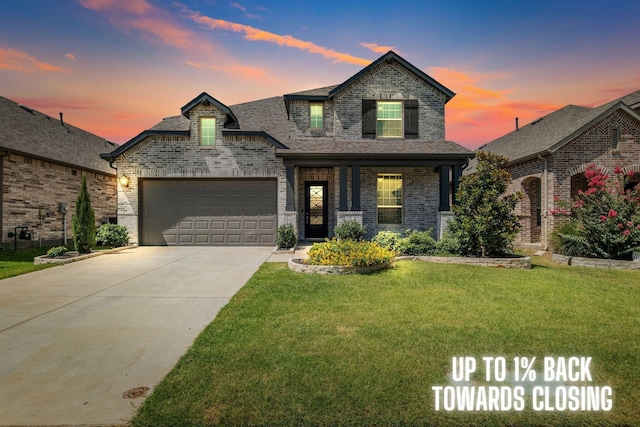 french country style house featuring a garage and a lawn