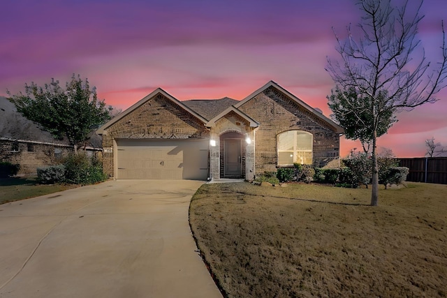 view of front of house with a yard and a garage