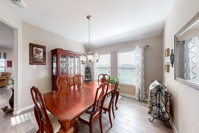 dining area with a chandelier and light hardwood / wood-style floors