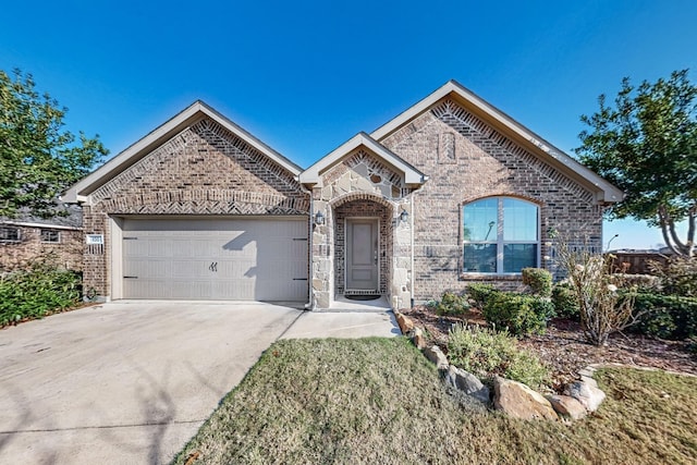 100 Antler Trl, Forney, TX 75126 - view of front facade featuring a garage, brick siding, concrete driveway, and stone siding