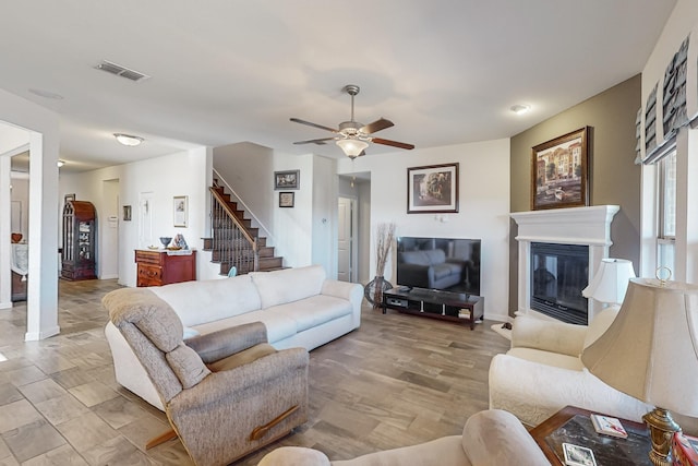 living room with ceiling fan and light wood-type flooring