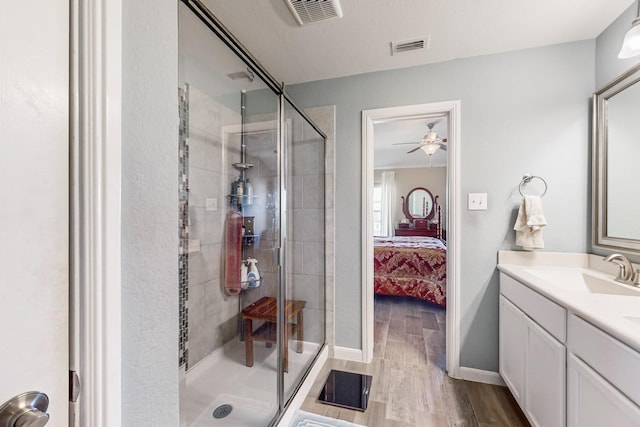 bathroom featuring ensuite bath, visible vents, a stall shower, and wood finished floors