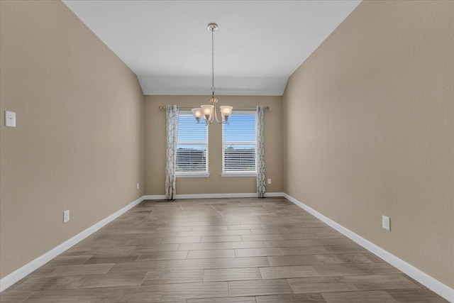 unfurnished dining area featuring baseboards, a chandelier, and wood finished floors