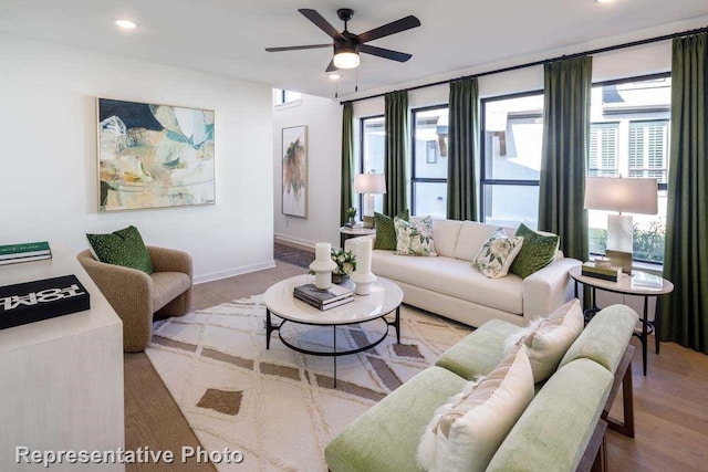 living room featuring hardwood / wood-style floors and ceiling fan