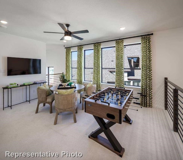 playroom featuring light carpet and ceiling fan