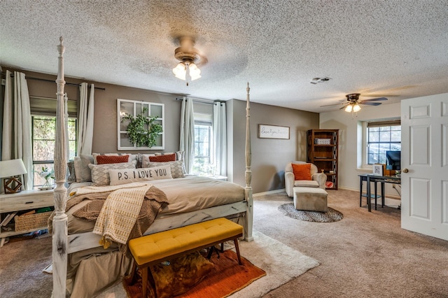 bedroom with ceiling fan, multiple windows, and carpet