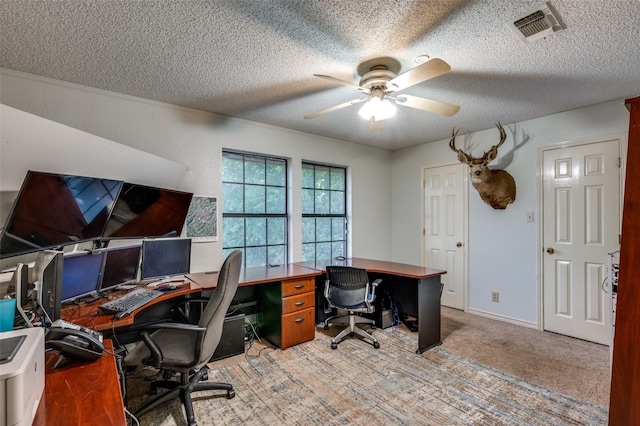 home office with ceiling fan, light carpet, and a textured ceiling