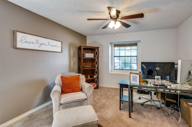 carpeted office with ceiling fan and a textured ceiling