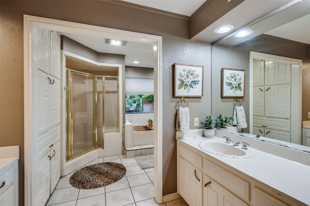 bathroom with tile patterned floors, vanity, and separate shower and tub