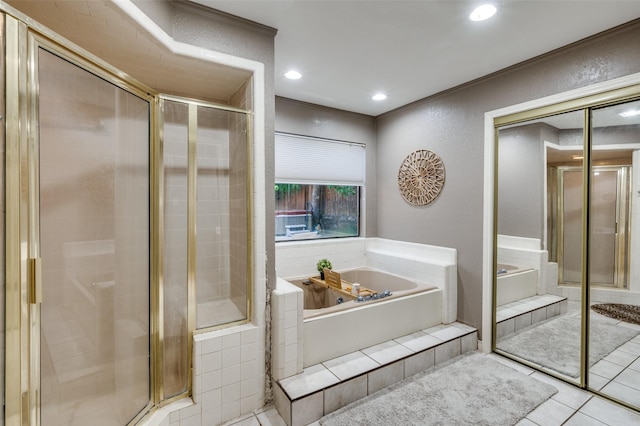 bathroom featuring tile patterned flooring and separate shower and tub