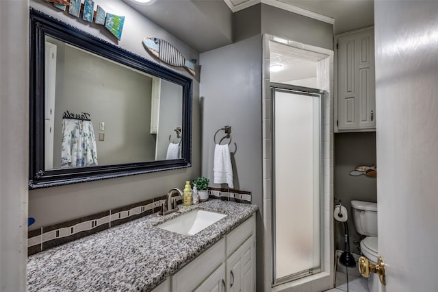 bathroom featuring vanity, toilet, and an enclosed shower