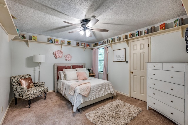 bedroom featuring ceiling fan, light colored carpet, and a textured ceiling