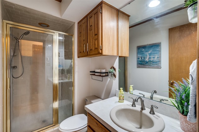 bathroom featuring vanity, toilet, and a shower with door