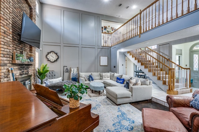 living room featuring a towering ceiling and a fireplace