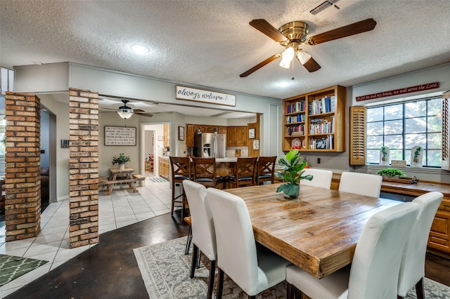 dining room featuring ceiling fan, a textured ceiling, and light tile patterned flooring