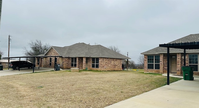 view of front of property with a carport and a front lawn