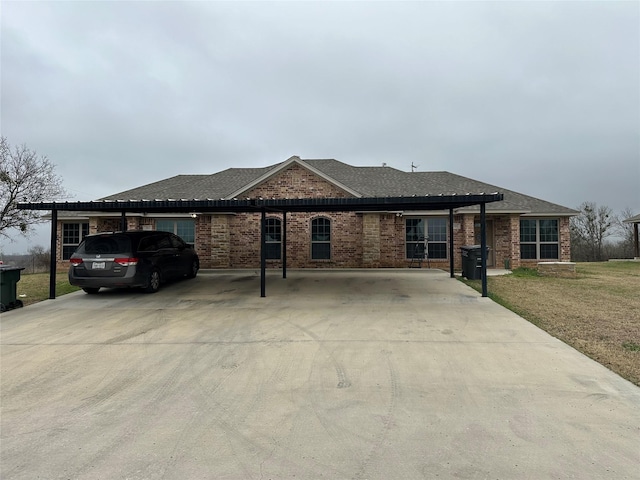 single story home with a front yard and a carport