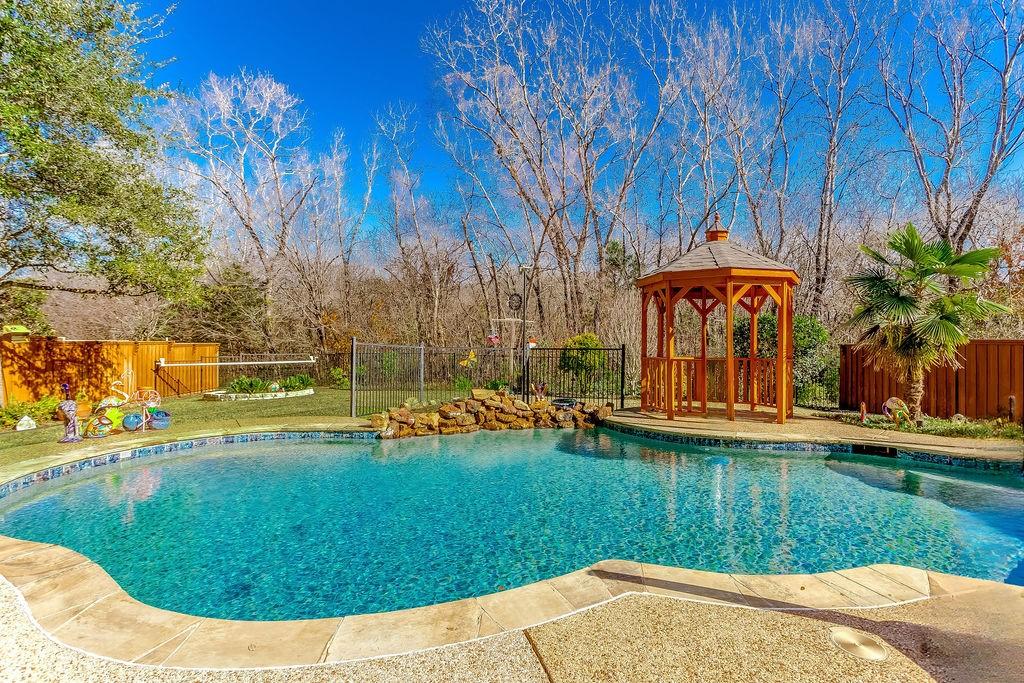 view of pool with a gazebo and a lawn