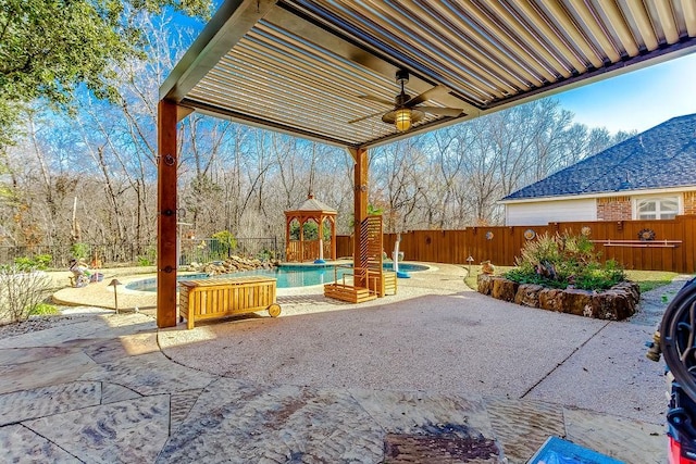 view of patio / terrace featuring a swimming pool with hot tub and ceiling fan