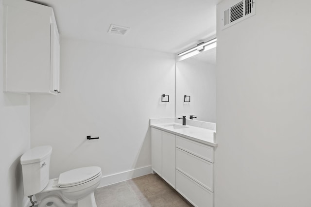 bathroom with tile patterned flooring, vanity, and toilet