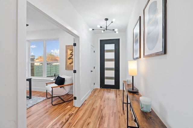 foyer with a notable chandelier and hardwood / wood-style flooring