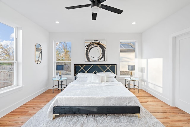 bedroom with ceiling fan and hardwood / wood-style flooring