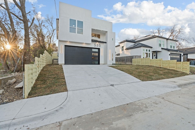 view of front of property featuring a garage and a front lawn