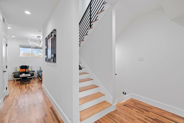 stairs with hardwood / wood-style flooring