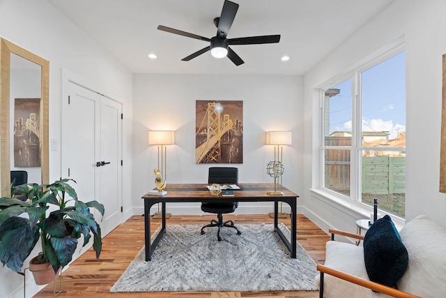 office area with ceiling fan and light hardwood / wood-style floors