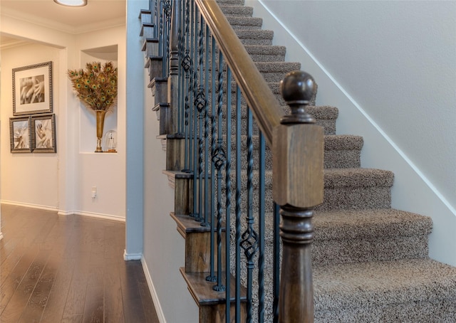 stairs featuring hardwood / wood-style flooring and ornamental molding