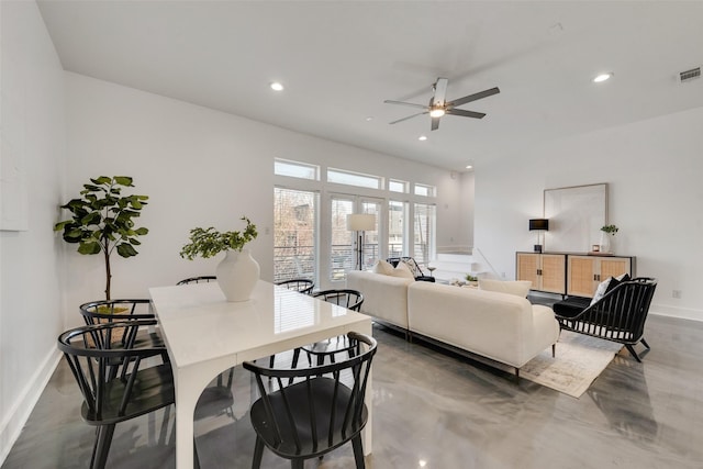 living room with concrete flooring and ceiling fan