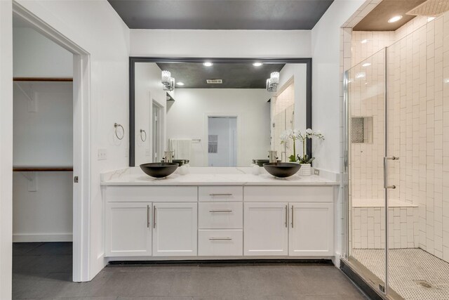 bathroom featuring vanity and a shower with shower door