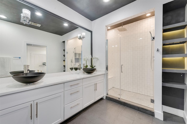 bathroom featuring vanity and a shower with shower door