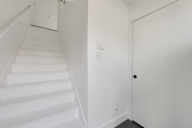 staircase featuring tile patterned floors