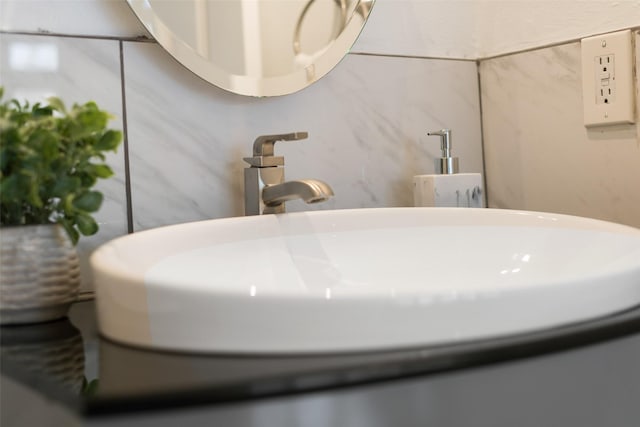 bathroom featuring sink and tile walls