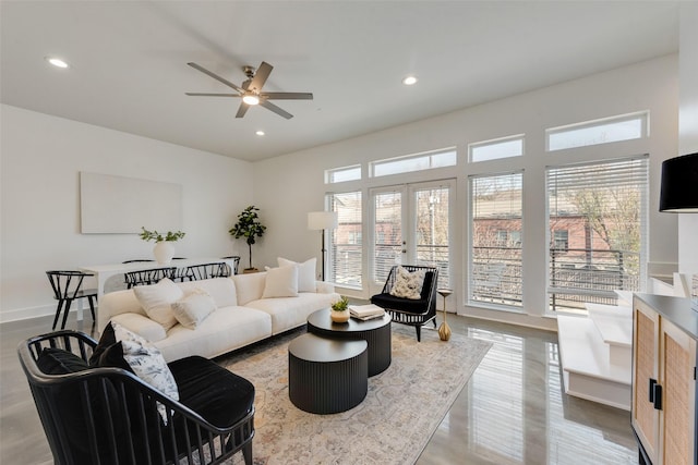 living room featuring ceiling fan and french doors