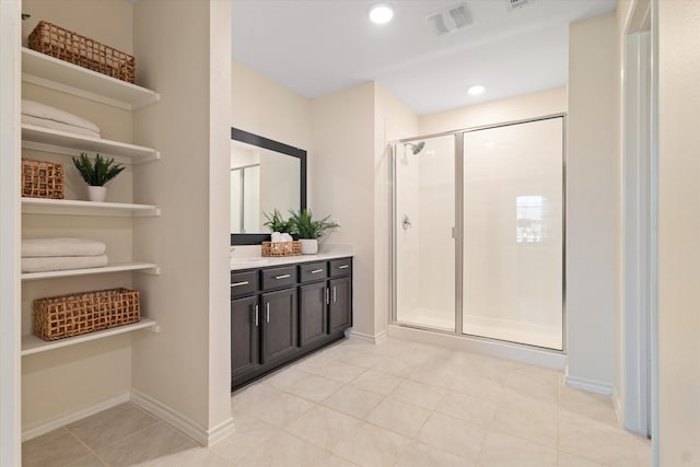 bathroom with tile patterned floors, vanity, and an enclosed shower