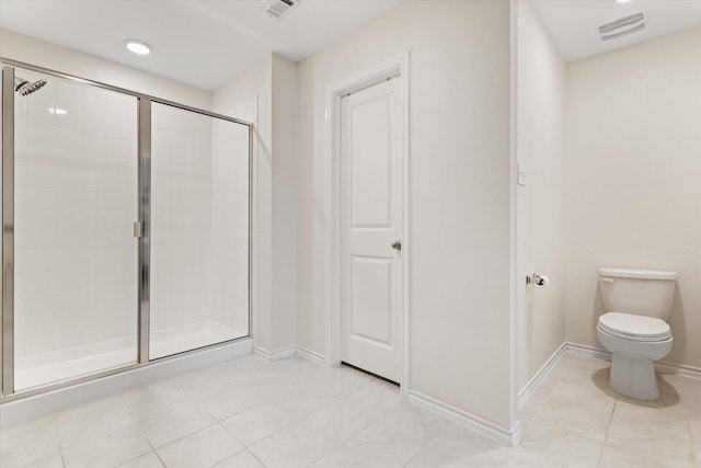 bathroom featuring tile patterned flooring, a shower with shower door, and toilet