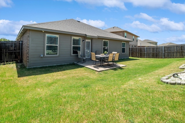 back of property featuring a yard and a patio